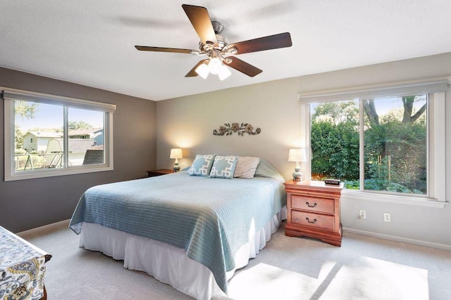 bedroom featuring multiple windows and light carpet