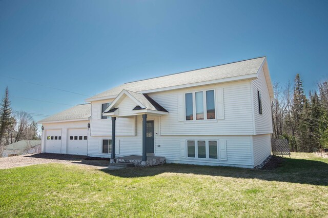 500 5th St, Grand Marais, MN 55604 - raised ranch featuring dirt driveway, an attached garage, roof with shingles, and a front yard