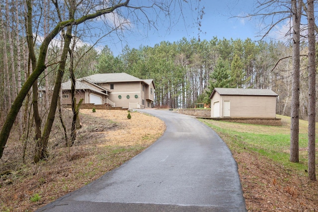 265 Red Pine Trl, Saint Joseph Twp, WI 54016 - view of asphalt driveway featuring a view of trees