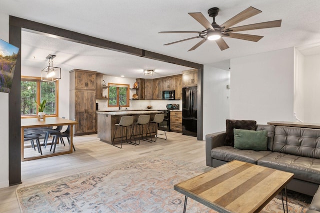 265 Red Pine Trl, Saint Joseph Twp, WI 54016 - living room with ceiling fan, light wood finished floors, and beam ceiling