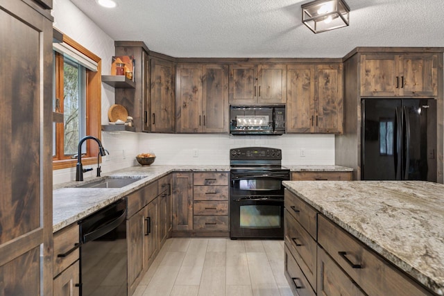 265 Red Pine Trl, Saint Joseph Twp, WI 54016 - kitchen featuring black appliances, a sink, light stone counters, decorative backsplash, and a textured ceiling