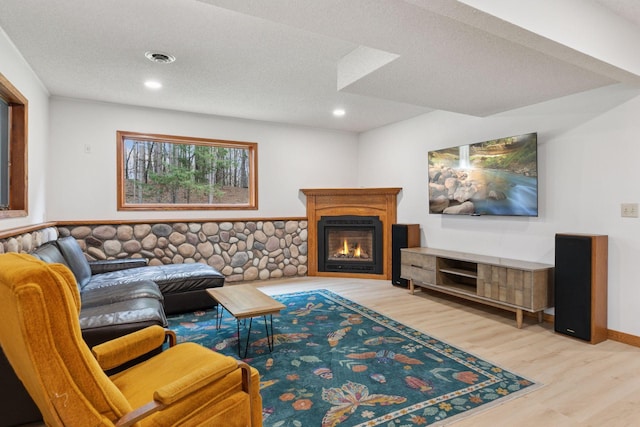 265 Red Pine Trl, Saint Joseph Twp, WI 54016 - living room featuring wood finished floors, a glass covered fireplace, recessed lighting, and a textured ceiling