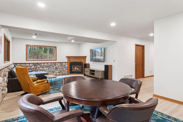 265 Red Pine Trl, Saint Joseph Twp, WI 54016 - living room featuring light wood-style flooring, a glass covered fireplace, and recessed lighting