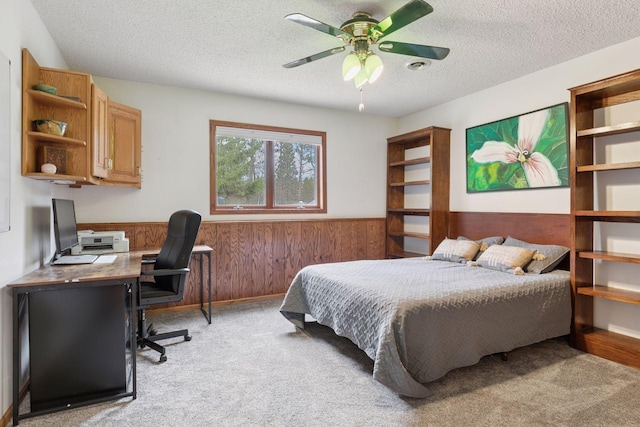 265 Red Pine Trl, Saint Joseph Twp, WI 54016 - bedroom featuring light colored carpet, a wainscoted wall, a textured ceiling, an office area, and wooden walls