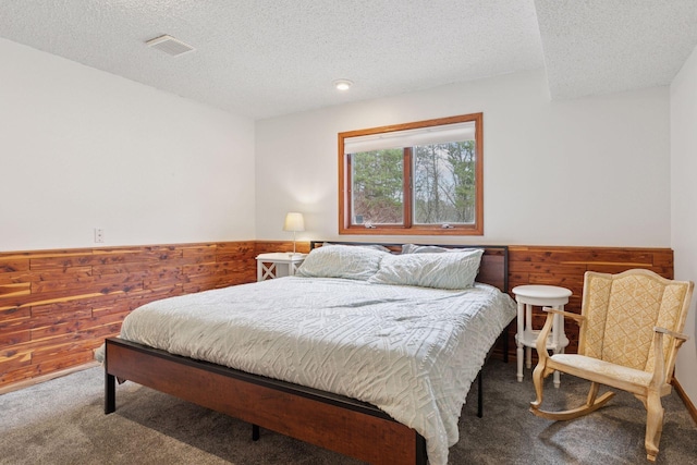265 Red Pine Trl, Saint Joseph Twp, WI 54016 - carpeted bedroom with wainscoting, wood walls, and a textured ceiling