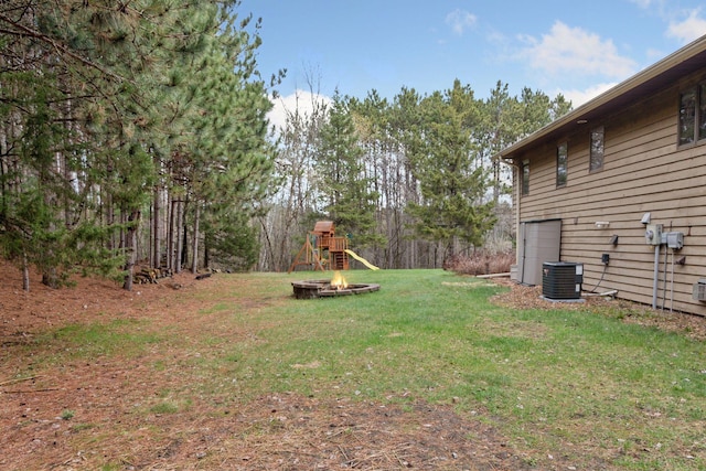 265 Red Pine Trl, Saint Joseph Twp, WI 54016 - view of grassy yard with a fire pit and central AC