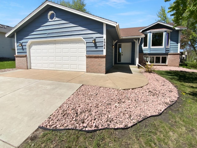 4984 Park Dr, Savage, MN 55378 - ranch-style home featuring brick siding, driveway, and a garage