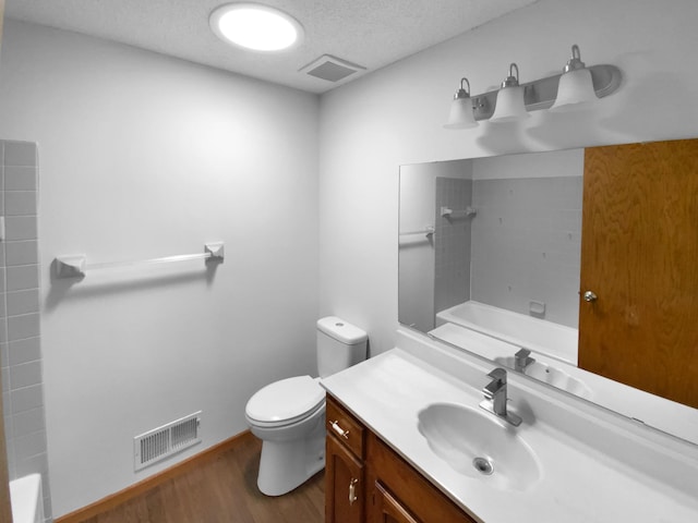 4984 Park Dr, Savage, MN 55378 - full bathroom featuring wood finished floors, toilet, vanity, a textured ceiling, and tub / shower combination