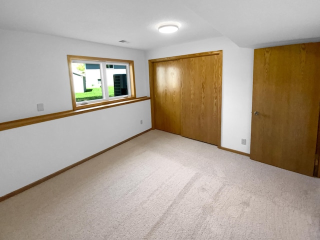 4984 Park Dr, Savage, MN 55378 - unfurnished bedroom featuring light colored carpet, a closet, and baseboards