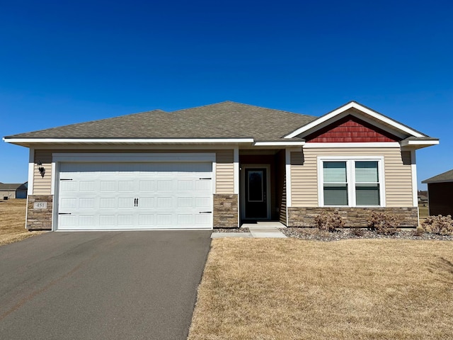 155 Summerfield Dr, Waverly, MN 55390 - view of front of property with stone siding, asphalt driveway, an attached garage, and a front lawn