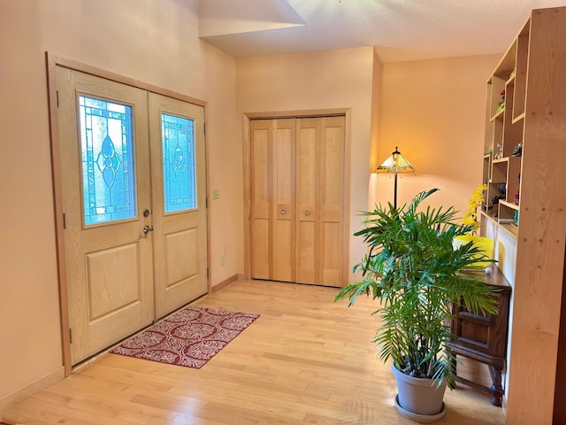 766 County Road F E, Vadnais Heights, MN 55127 - foyer featuring light wood-style floors, baseboards, and a textured ceiling