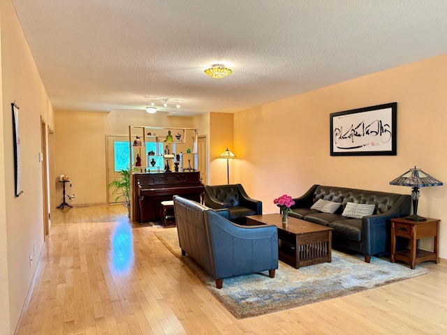 766 County Road F E, Vadnais Heights, MN 55127 - living area featuring light wood-type flooring, a textured ceiling, and baseboards