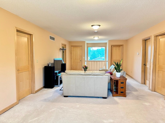 766 County Road F E, Vadnais Heights, MN 55127 - living area featuring light colored carpet, a textured ceiling, and baseboards