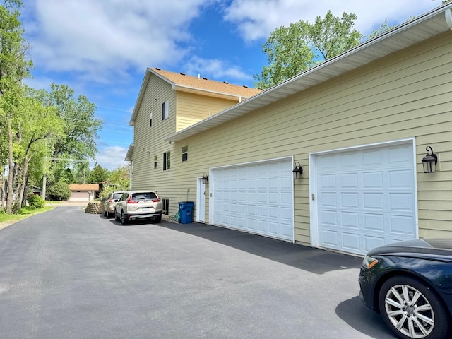 766 County Road F E, Vadnais Heights, MN 55127 - view of side of home featuring driveway and a garage