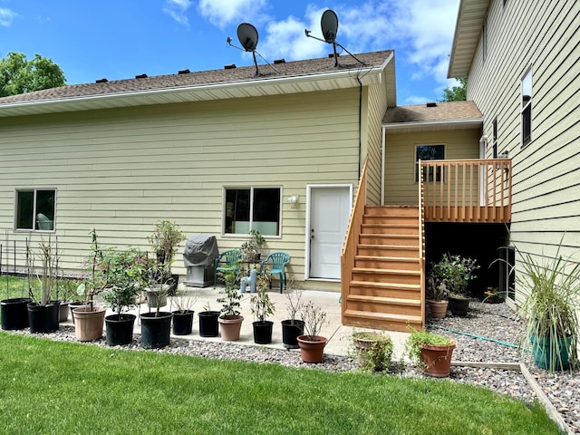 766 County Road F E, Vadnais Heights, MN 55127 - back of house featuring stairway, a deck, a patio area, a yard, and a shingled roof