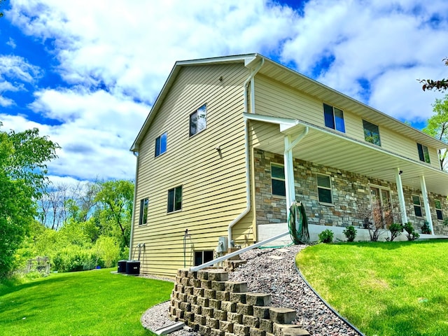 766 County Road F E, Vadnais Heights, MN 55127 - view of side of home with a lawn and stone siding