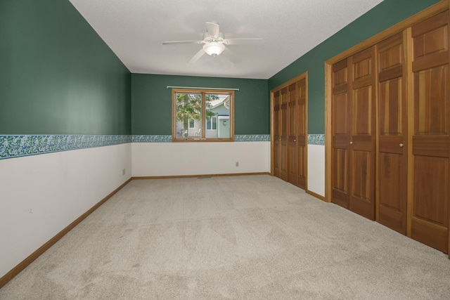 1922 Eastridge Ct, Stillwater, MN 55082 - unfurnished bedroom featuring light carpet, two closets, a ceiling fan, and baseboards