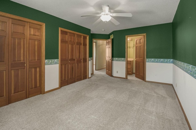 1922 Eastridge Ct, Stillwater, MN 55082 - unfurnished bedroom with light colored carpet, multiple closets, ceiling fan, baseboards, and ensuite bath