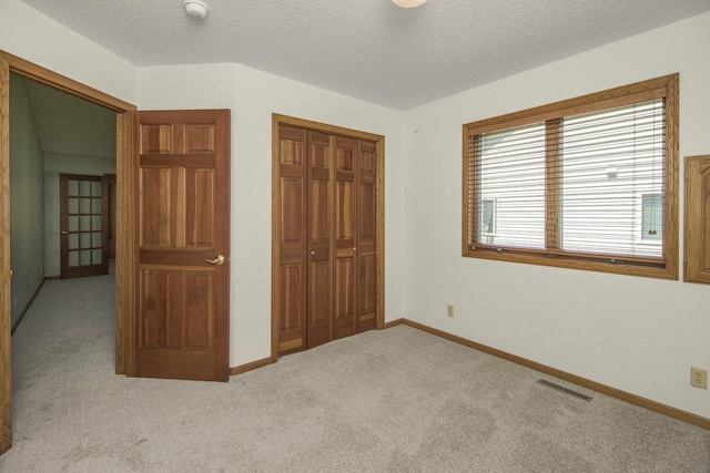 1922 Eastridge Ct, Stillwater, MN 55082 - unfurnished bedroom featuring carpet floors, a closet, baseboards, and a textured ceiling