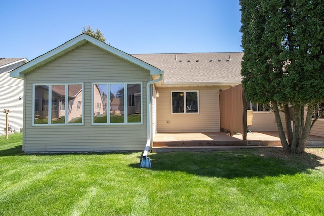 1922 Eastridge Ct, Stillwater, MN 55082 - rear view of house featuring a deck, roof with shingles, and a lawn