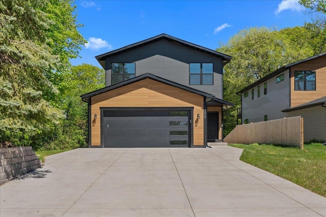 3822 Northern Ave, Spring Park, MN 55384 - contemporary home with concrete driveway, a garage, and fence
