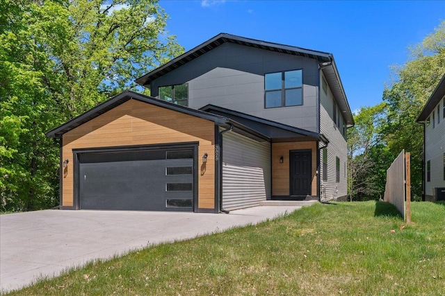 3822 Northern Ave, Spring Park, MN 55384 - modern home with concrete driveway, a front lawn, an attached garage, and central air condition unit