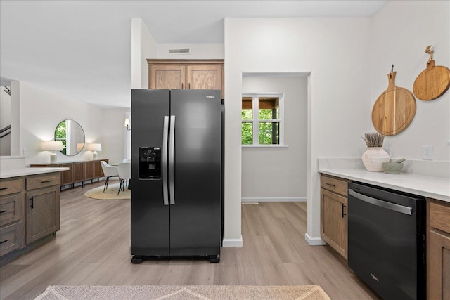 3822 Northern Ave, Spring Park, MN 55384 - kitchen with stainless steel appliances, light wood-style floors, light countertops, baseboards, and brown cabinetry