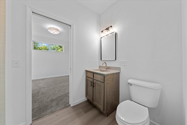 3822 Northern Ave, Spring Park, MN 55384 - bathroom featuring wood finished floors, toilet, vanity, and baseboards