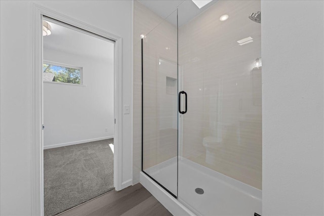 3822 Northern Ave, Spring Park, MN 55384 - full bath featuring a stall shower, baseboards, and wood finished floors