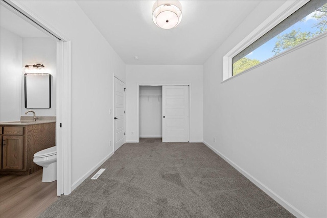 3822 Northern Ave, Spring Park, MN 55384 - unfurnished bedroom featuring a sink, ensuite bath, a closet, and baseboards