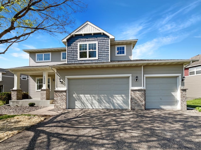craftsman house featuring driveway, a porch, and an attached garage