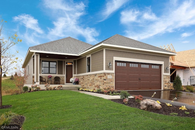 13714 Park Haven Trl NE, Prior Lake, MN 55372 - view of front facade featuring stone siding, an attached garage, a front lawn, and roof with shingles