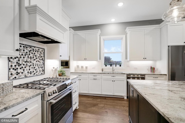 13714 Park Haven Trl NE, Prior Lake, MN 55372 - kitchen with stainless steel appliances, a sink, custom range hood, white cabinets, and recessed lighting