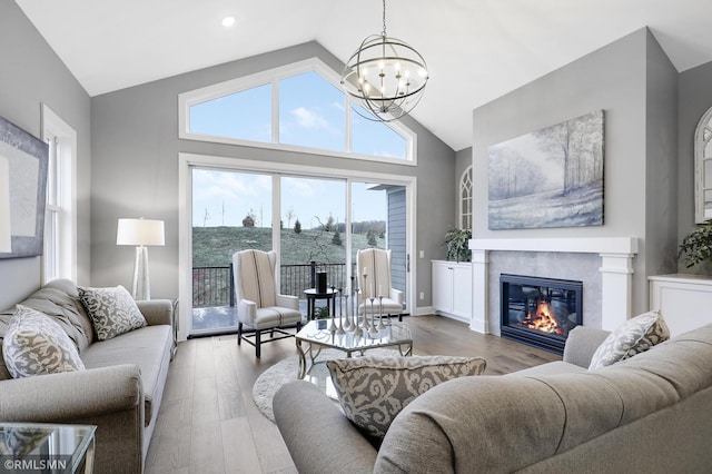 13714 Park Haven Trl NE, Prior Lake, MN 55372 - living room with a chandelier, wood finished floors, high vaulted ceiling, a glass covered fireplace, and recessed lighting