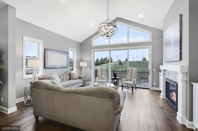 13714 Park Haven Trl NE, Prior Lake, MN 55372 - living area featuring a glass covered fireplace, dark wood finished floors, a chandelier, baseboards, and high vaulted ceiling
