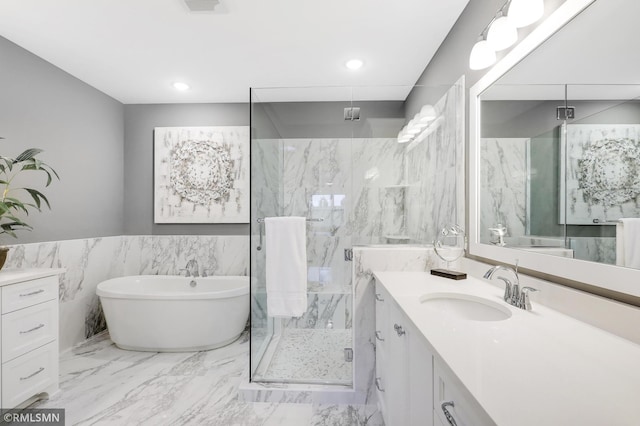 13714 Park Haven Trl NE, Prior Lake, MN 55372 - bathroom with a marble finish shower, vanity, marble finish floors, a freestanding tub, and tile walls