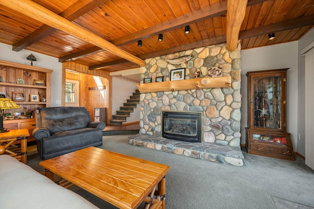 19490 Ruff Shores Rd, Harris Twp, MN 55744 - carpeted living room featuring wooden ceiling, beam ceiling, stairs, baseboards, and a stone fireplace