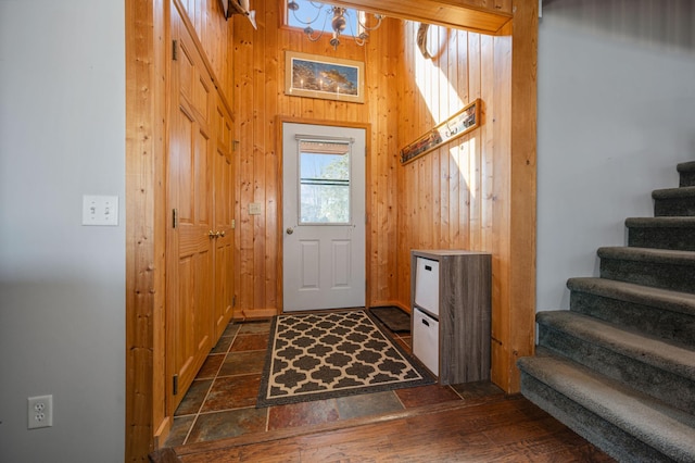 19490 Ruff Shores Rd, Harris Twp, MN 55744 - entryway featuring stairs, wooden walls, and a chandelier