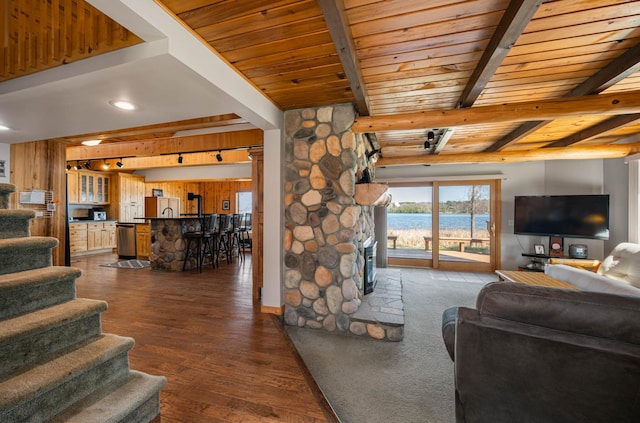 19490 Ruff Shores Rd, Harris Twp, MN 55744 - living area featuring wooden ceiling, beamed ceiling, dark wood-style floors, stairs, and a fireplace