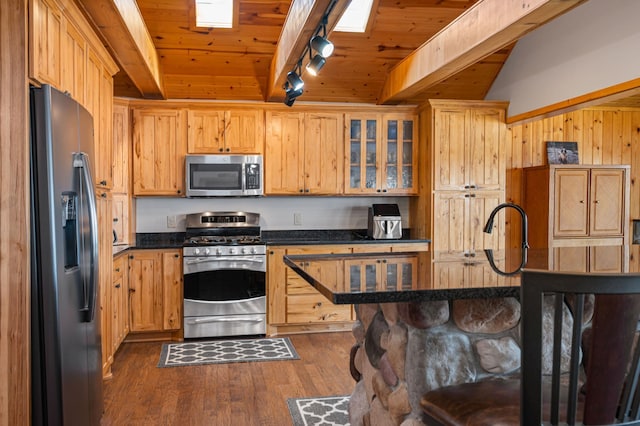 19490 Ruff Shores Rd, Harris Twp, MN 55744 - kitchen featuring stainless steel appliances, track lighting, a breakfast bar, dark wood-style flooring, and wooden ceiling