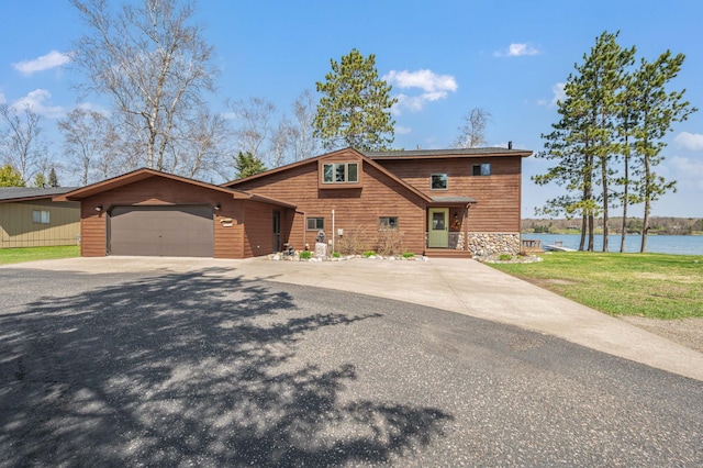 19490 Ruff Shores Rd, Harris Twp, MN 55744 - chalet / cabin with an attached garage, driveway, a water view, and stone siding