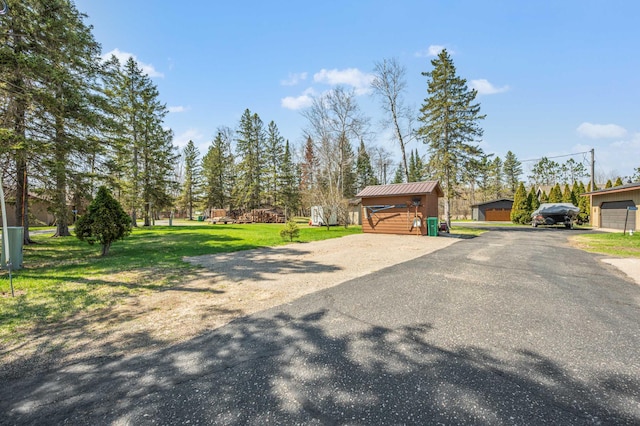 19490 Ruff Shores Rd, Harris Twp, MN 55744 - view of front of house featuring an outdoor structure, a front lawn, and metal roof