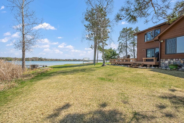 19490 Ruff Shores Rd, Harris Twp, MN 55744 - view of green lawn featuring a deck with water view