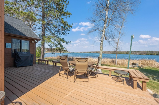 19490 Ruff Shores Rd, Harris Twp, MN 55744 - wooden deck featuring a grill, outdoor dining area, and a water view
