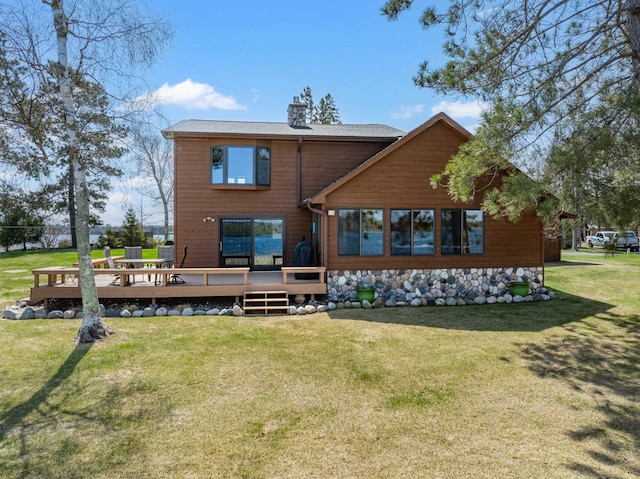 19490 Ruff Shores Rd, Harris Twp, MN 55744 - rear view of house with a wooden deck, a yard, and a chimney