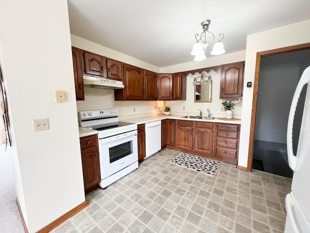 1950 Summit Ave, Worthington, MN 56187 - kitchen with white appliances, under cabinet range hood, a sink, light countertops, and a chandelier