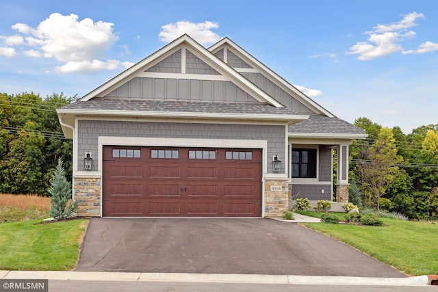 4104 Osprey Ct, Prior Lake, MN 55372 - craftsman house with board and batten siding, stone siding, a front lawn, and asphalt driveway