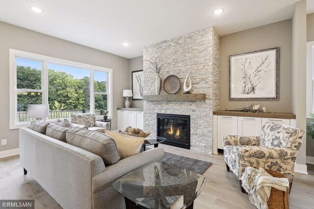 4104 Osprey Ct, Prior Lake, MN 55372 - living room with a fireplace, light wood-style floors, recessed lighting, and baseboards