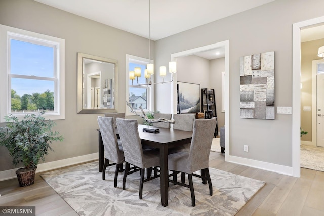 4104 Osprey Ct, Prior Lake, MN 55372 - dining room featuring a chandelier, light wood-style floors, and baseboards