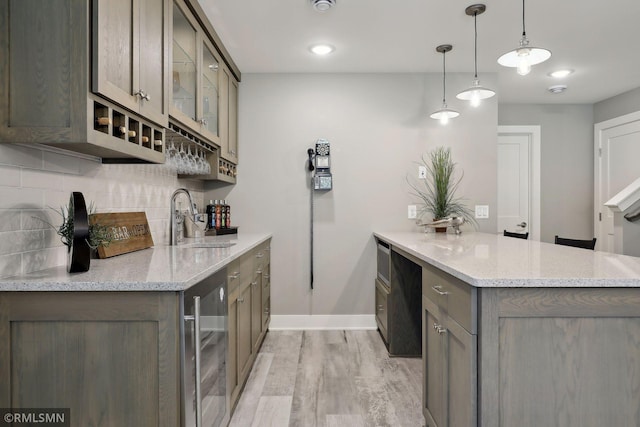 4104 Osprey Ct, Prior Lake, MN 55372 - bar with wine cooler, backsplash, light wood-style flooring, baseboards, and a sink